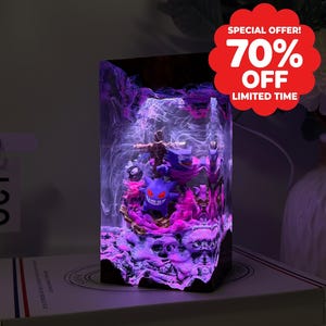 May include: A rectangular resin night light featuring a purple Gengar character figurine encased within a clear block. The interior displays swirling white smoke-like patterns and vibrant pink and purple LED lighting effects throughout the structure.