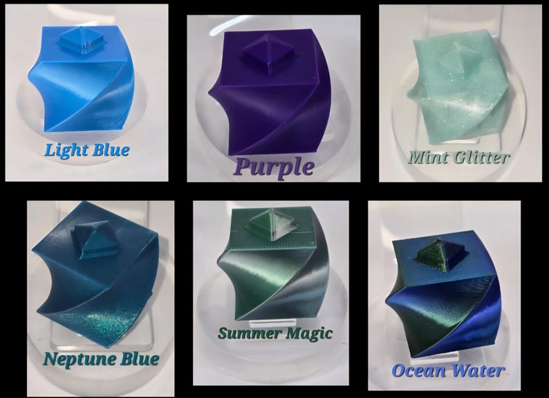 May include: Six 3D-printed twisted cube containers with pyramid-shaped lids in various colours: Light Blue, Purple, Mint Glitter, Neptune Blue, Summer Magic, and Ocean Water. Each cube features a spiralling geometric design and a square base.