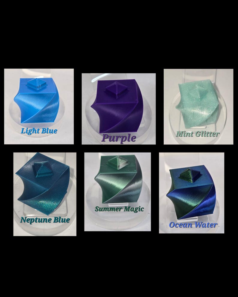 May include: A collection of six 3D-printed geometric sculptures in various colors. The colors include light blue, purple, mint glitter, neptune blue, summer magic, and ocean water. Each sculpture has a square top and a twisted base, with the color name displayed below each.