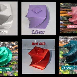 May include: A collection of six 3D printed geometric objects featuring a twisted square prism design with a pyramid top. The colours include white silk, lilac, pink glitter, green silk, red silk, and forest glitter, each labelled with its colour name.