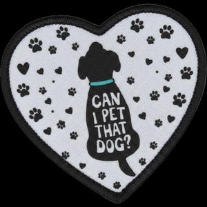 May include: A heart-shaped embroidered patch with a white background and a black border. The centre features a black silhouette of a dog wearing a teal collar, with the white text CAN I PET THAT DOG? printed on its body, surrounded by black paw prints.