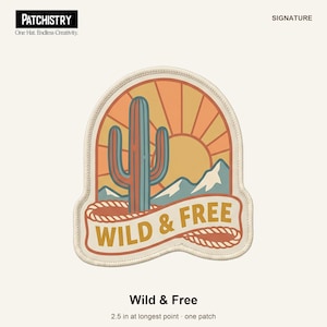 May include: A patch featuring a blue cactus, mountains, and a yellow sun against an orange sky. A banner at the bottom contains the text WILD & FREE in yellow letters. The patch has a cream-coloured border and measures 6.35 cm at its longest point.
