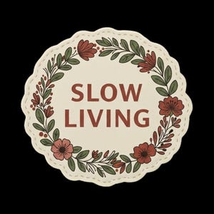May include: A circular patch with a scalloped edge featuring the text SLOW LIVING in dark red letters. The center is cream-colored and surrounded by a botanical wreath of dark red flowers, green leaves, and small red berries on a light background.