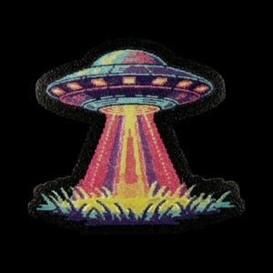 May include: A fabric patch featuring a colorful UFO design. The spacecraft is depicted in shades of blue, purple, and pink with yellow lights. A bright yellow beam of light extends downward from the center, illuminating a patch of dark purple grass.