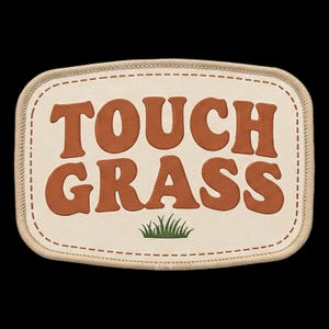 May include: A rectangular embroidered patch with rounded corners featuring a cream-colored background and a tan stitched border. The text TOUCH GRASS is embroidered in large, bold, burnt orange letters above a small green grass graphic.