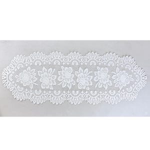 May include: White lace table runner with a floral design. The runner has a scalloped edge and a repeating floral pattern. The delicate lace adds elegance to any table setting. The runner is approximately 152 cm long.