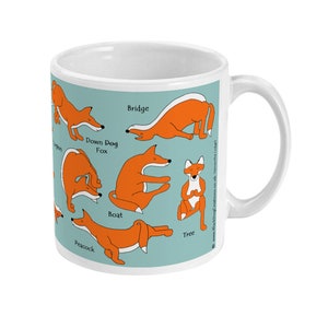 May include: White ceramic mug with a blue background and illustrations of foxes in different yoga poses. The poses are labeled with the names: Down Dog Fox, Bridge, Boat, Tree, Peacock.