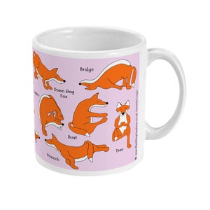 May include: White ceramic mug with a pink background featuring illustrations of a fox in various yoga poses. The poses are labeled with the names: Bridge, Down Dog Fox, Boat, Tree, and Peacock.