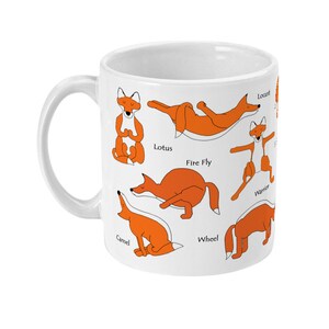 May include: White ceramic mug with an orange fox in different yoga poses, including Lotus, Fire Fly, Warrior, Camel, Wheel, and Locust. The poses are labeled with their names.