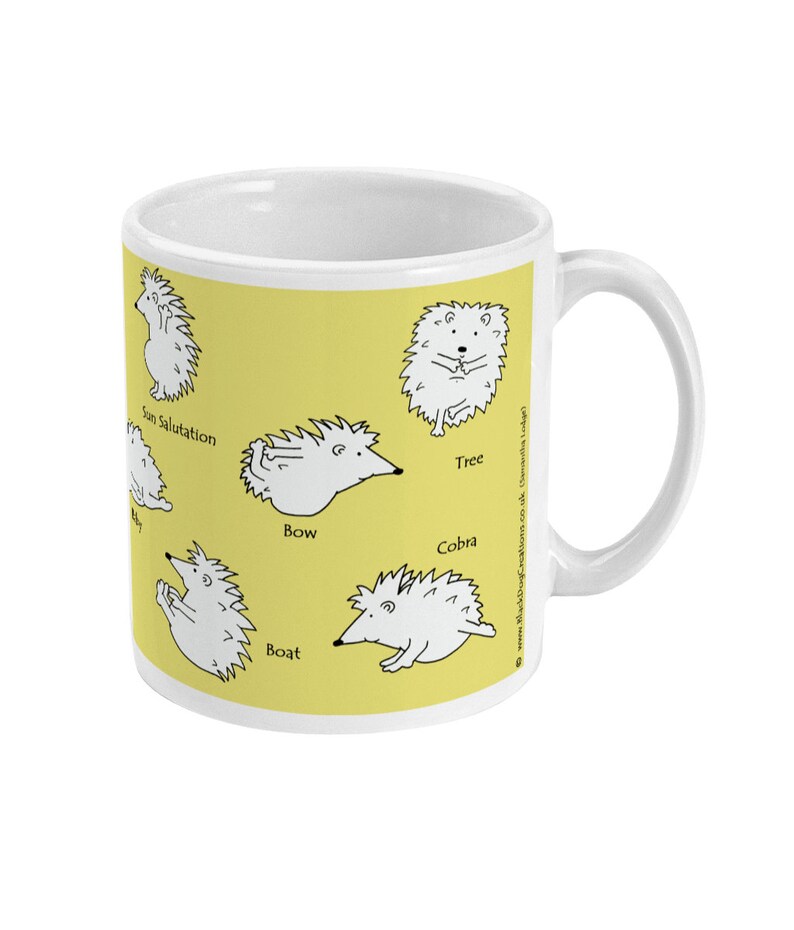May include: White ceramic mug with a yellow background featuring cartoon hedgehogs in various yoga poses. Poses include Sun Salutation, Tree, Bow, Cobra, and Boat. The mug has a white handle and a white interior.