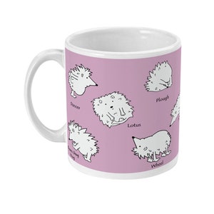 May include: White ceramic mug with a light purple background featuring cartoon hedgehogs in various poses. The mug has a white handle and the names of the poses are printed below each hedgehog. A fun and whimsical design.
