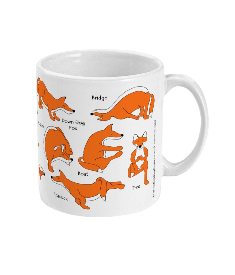 May include: White ceramic mug with an orange fox in different yoga poses, including Down Dog Fox, Bridge, Boat, Tree, and Peacock. The text on the mug reads "Down Dog Fox", "Bridge", "Boat", "Tree", and "Peacock".