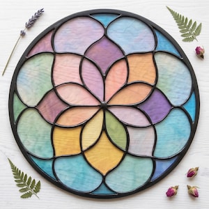 May include: A circular stained glass panel featuring a geometric flower-like pattern with multiple segments. Each segment displays a soft, translucent pastel color including shades of blue, pink, yellow, purple, and green, all encased in a black frame.