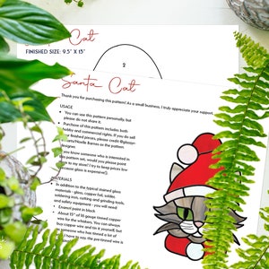 May include: A printed pattern for a stained glass Santa Cat, with a finished size of 9.5" x 13". The design features a gray cat wearing a red Santa hat. The pattern includes usage instructions and materials needed for the project.