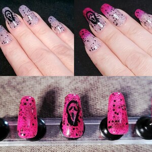 May include: A set of press-on nails with a spooky theme. The nails feature a gradient design with black speckles and a black Scream mask. The nails are shown in a variety of colors, including pink and purple.