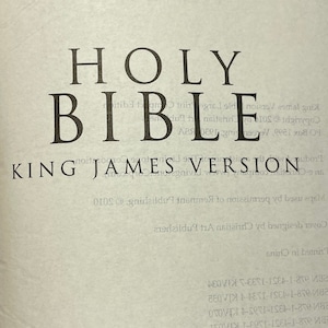 May include: A close-up of the cover of a Holy Bible, King James Version, published by Christian Art Publishers. The cover is designed by Christian Art Publishers and printed in China.