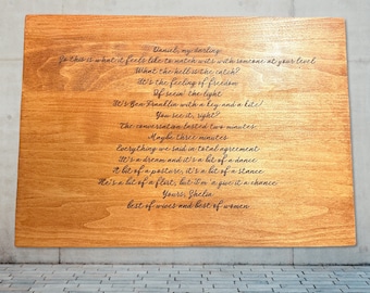 May include: A wooden plaque with a poem engraved in cursive script. The poem is about a relationship and includes the lines "So this is what it feels like to match wits with someone at your level" and "It's a dream and it's a bit of a dance".