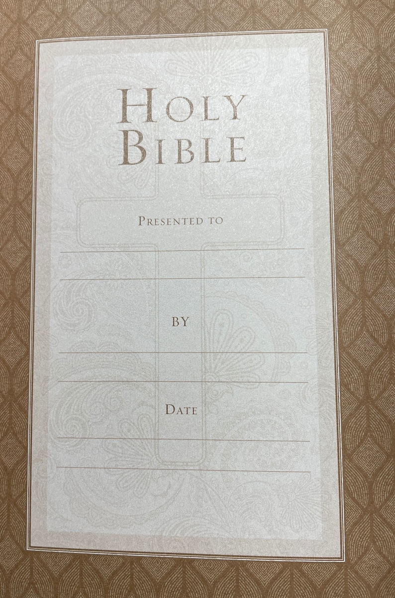 May include: A white card with a brown border and the words "HOLY BIBLE" printed in black. The card has blank lines for "PRESENTED TO", "BY", and "DATE".