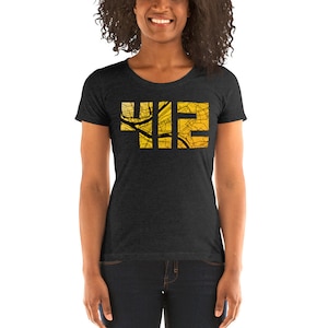 May include: A dark heather grey women's t-shirt with a yellow and black graphic of the number "412" made up of a city map.