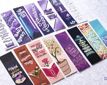 May include: A collection of rectangular paper bookmarks featuring various colourful graphic designs and literary quotes. The bookmarks display diverse illustrations including books, cocktails, roses, and space themes with text such as Only One Bed and Romance Reasons.