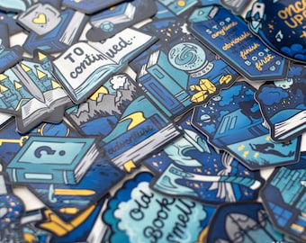 May include: A collection of blue and yellow book-themed stickers with various designs, including a castle, a book with the words "To continued..." on it, a book with the words "Adventure" on it, a book with the words "Old Book Smell" on it, a book with the words "Stop anytime you want to finish the book first." on it, and a book with the words "Once Upon a Time" on it.