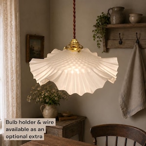 May include: A pendant light featuring a translucent, ruffled glass shade with a textured, diamond-patterned surface. The shade is suspended by a twisted brown cord attached to a polished brass fixture. Bulb holder and wire available as an optional extra.