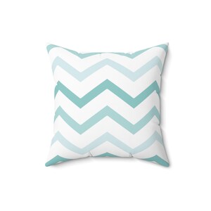 May include: A white pillow with a teal chevron pattern.