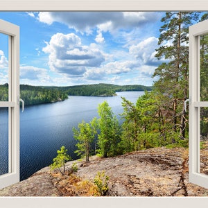 May include: A white window frame with a view of a lake surrounded by trees and a blue sky with white clouds. The window is open and the view is framed by the window.