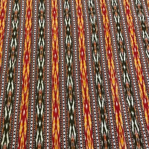 Handwoven cotton ikat stripe textile in rich tones from Guatemala.