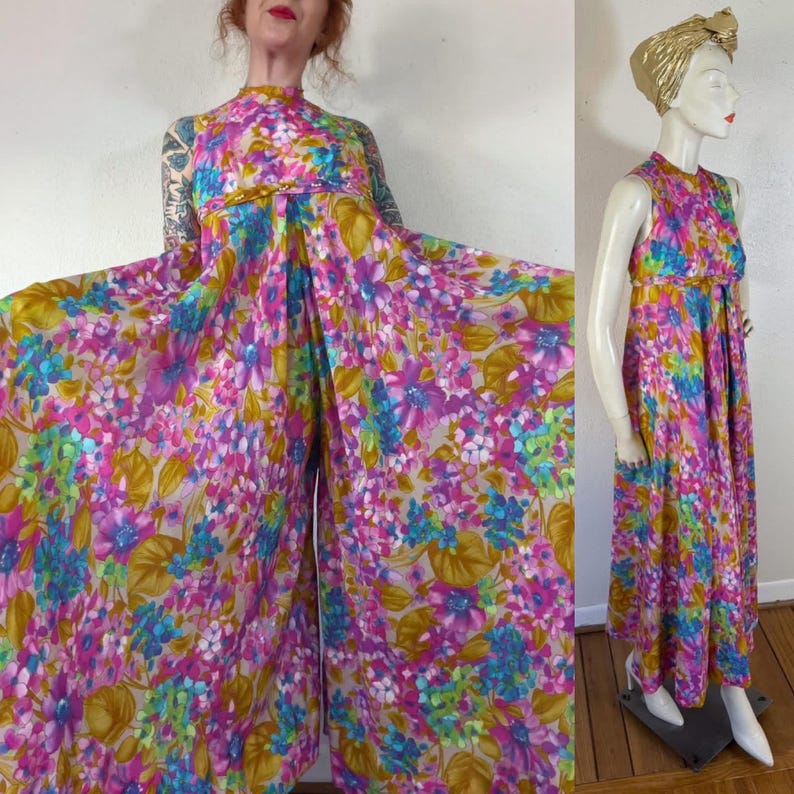 May include: A vintage floral print jumpsuit in shades of pink, blue, and yellow. The sleeveless jumpsuit features a high neckline and a wide-leg design. The fabric is adorned with a vibrant floral pattern, creating a retro aesthetic.