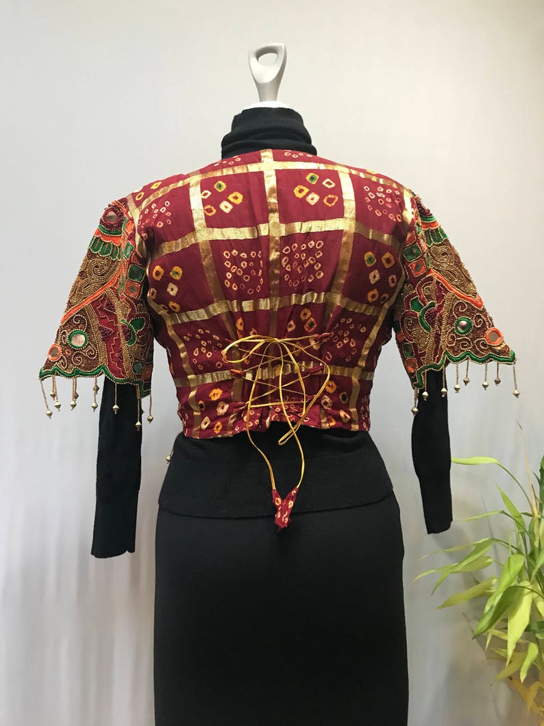 Stunning ornate vintage jacket reminds me of a butterfly.