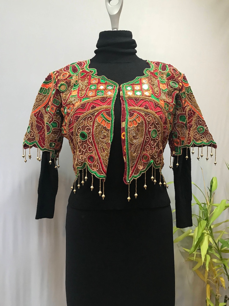Stunning ornate vintage jacket reminds me of a butterfly.