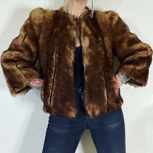 Vintage 1940’s/1950’s shades of caramel cropped paneled shearling jacket with vertical panels bound by grosgrain, front welt pockets and the image 1