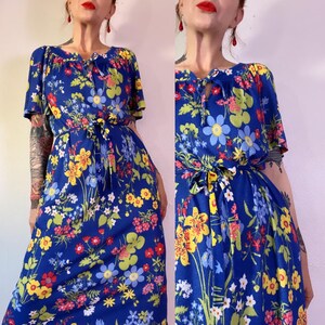 Vintage 1960’s/1970s blue terry cloth dress in the most vibrant & playful floral print with waist tie, side pockets, raglan flutter sleeves