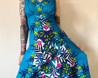 Vintage 1960’s/1970’s bright and bold floral print cotton barkcloth maxi dress with double v-neckline, pleated sculpted bust, and incredibly