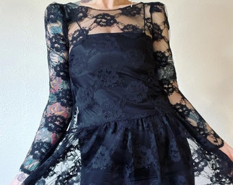 Vintage 1970’s/1980’s jet back lace babydoll style dress with gathered puff shoulder caps, scooped back and wiggle slip underlay by Brannan