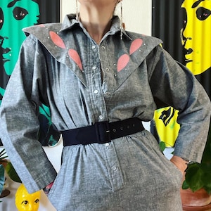 Vintage 1980’s black and white crossdye jumpsuit with pink snakeskin and rhinestone embellished exaggerated front yoke & side pockets