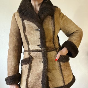 Vintage 1970’s burnished almond and rich mocha shearling coat with front pockets, wide lapel, 3pc sleeve, princess seams and plush shearling