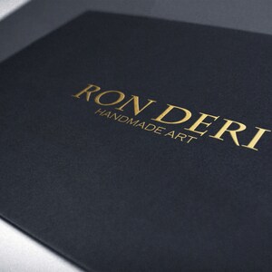 May include: A black card with the gold text "RONDERI HANDMADE ART" printed on it.
