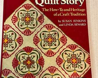 以下が含まれることがあります： スーザン・ジェンキンスとリンダ・スワードによる「The American Quilt Story: The How-To and Heritage of a Craft Tradition」というタイトルの赤い本。本の表紙にはカラフルなキルトのパターンと「Step-by-Step Directions for 30 Antique Quilts」というテキストが書かれています。
