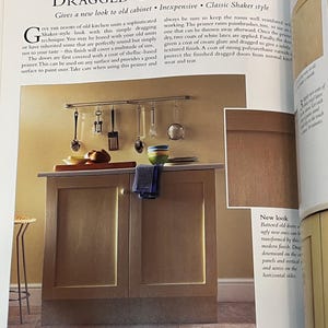 May include: A close-up of a kitchen cabinet with two doors. The cabinet doors are painted a light brown color and have a distressed, textured finish. The text "Dragged Cabinet Doors" is visible at the top of the image. The text "Gives a new look to old cabinet. Inexpensive. Classic Shaker style" is also visible.