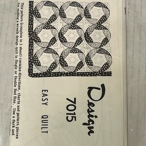 May include: A vintage quilt pattern sheet featuring a wreath design. The pattern includes directions and charts for single or double bed sizes. The sheet is labeled "Easy Quilt" with the design number 7015.