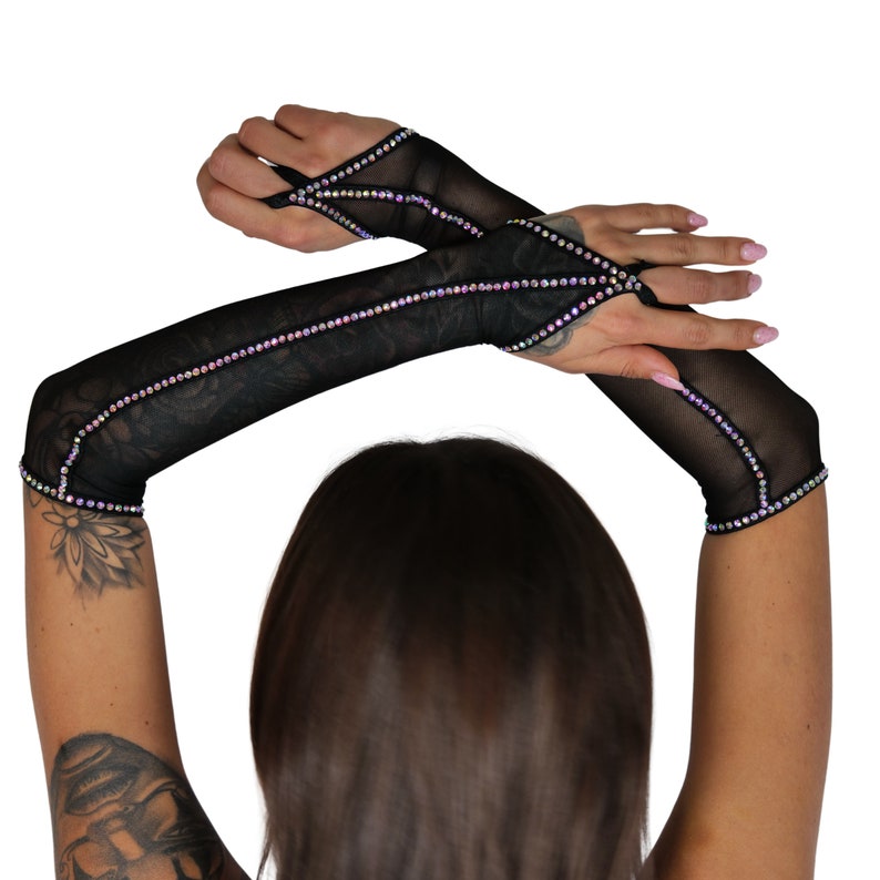 May include: A pair of black mesh fingerless gloves with iridescent rhinestones. The gloves have a cut-out design on the back of the hand.