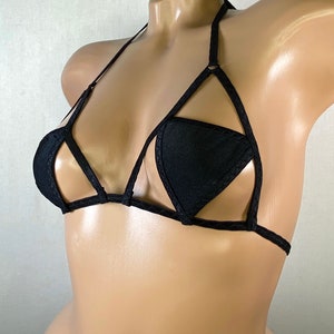 May include: Black triangle-shaped bra with a criss-cross design and adjustable straps.