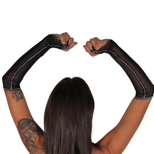 May include: A pair of black mesh fingerless gloves with iridescent rhinestones along the seams.