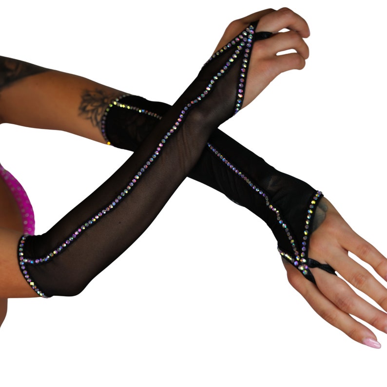 May include: A pair of black mesh elbow-length gloves with iridescent rhinestone detailing. The gloves have a fingerless design with a cut-out at the thumb.