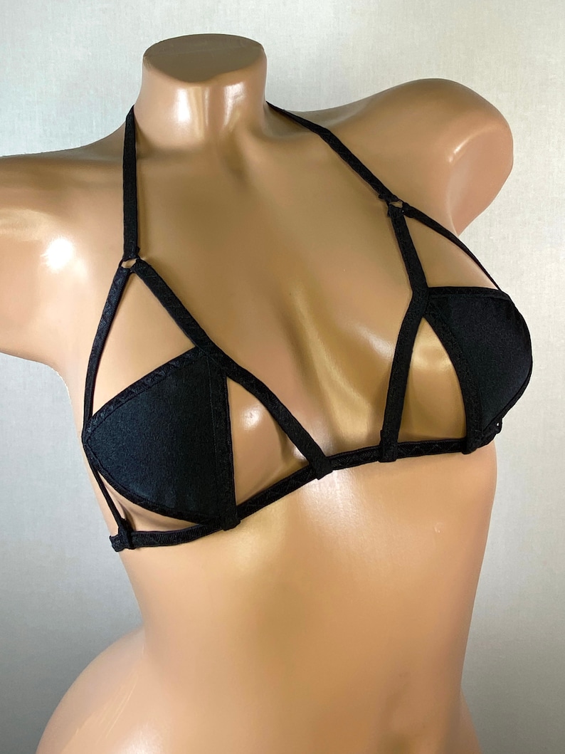 May include: Black lingerie bra with a geometric design and thin straps.