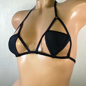 May include: Black lingerie top with a geometric design and a halter strap.