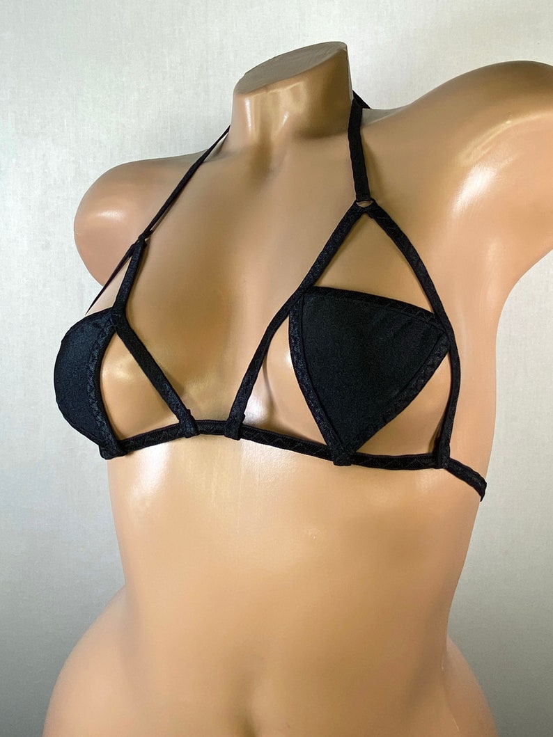 May include: Black lingerie top with a geometric design and a halter strap.