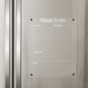 May include: A clear acrylic dry erase board with the text "Things To Do" at the top. The board is divided into sections for "Get It Done", "Shopping List", "Appointments", and "Notes".